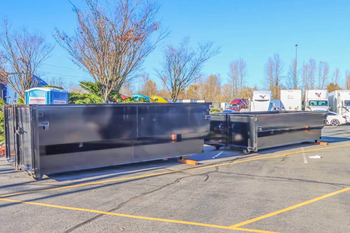 Professional dumpster rental service with roll-off container on residential driveway in Rice Lake